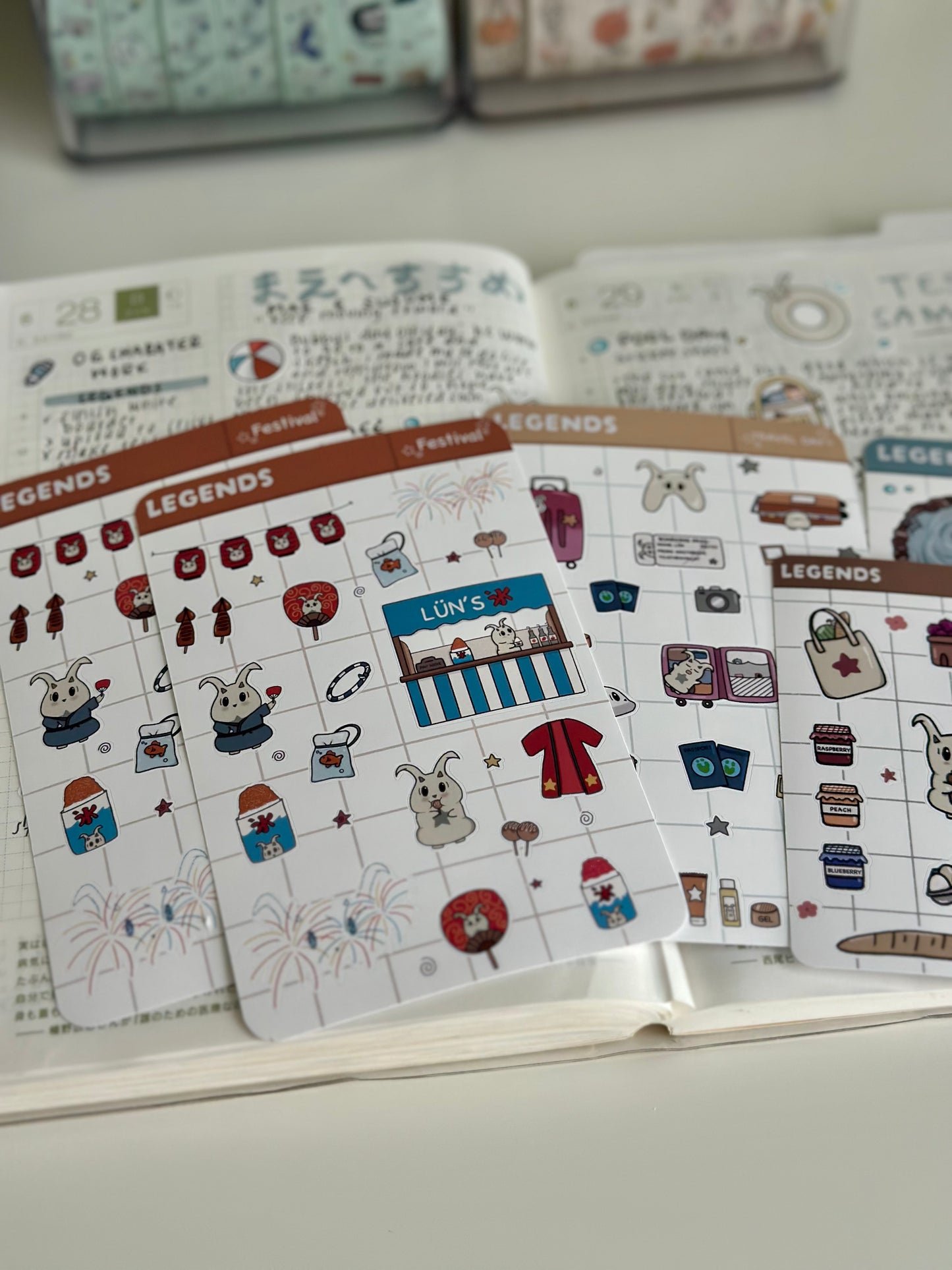 Some summer theme sticker sheeting including the firework festival sheet laying on my journal page