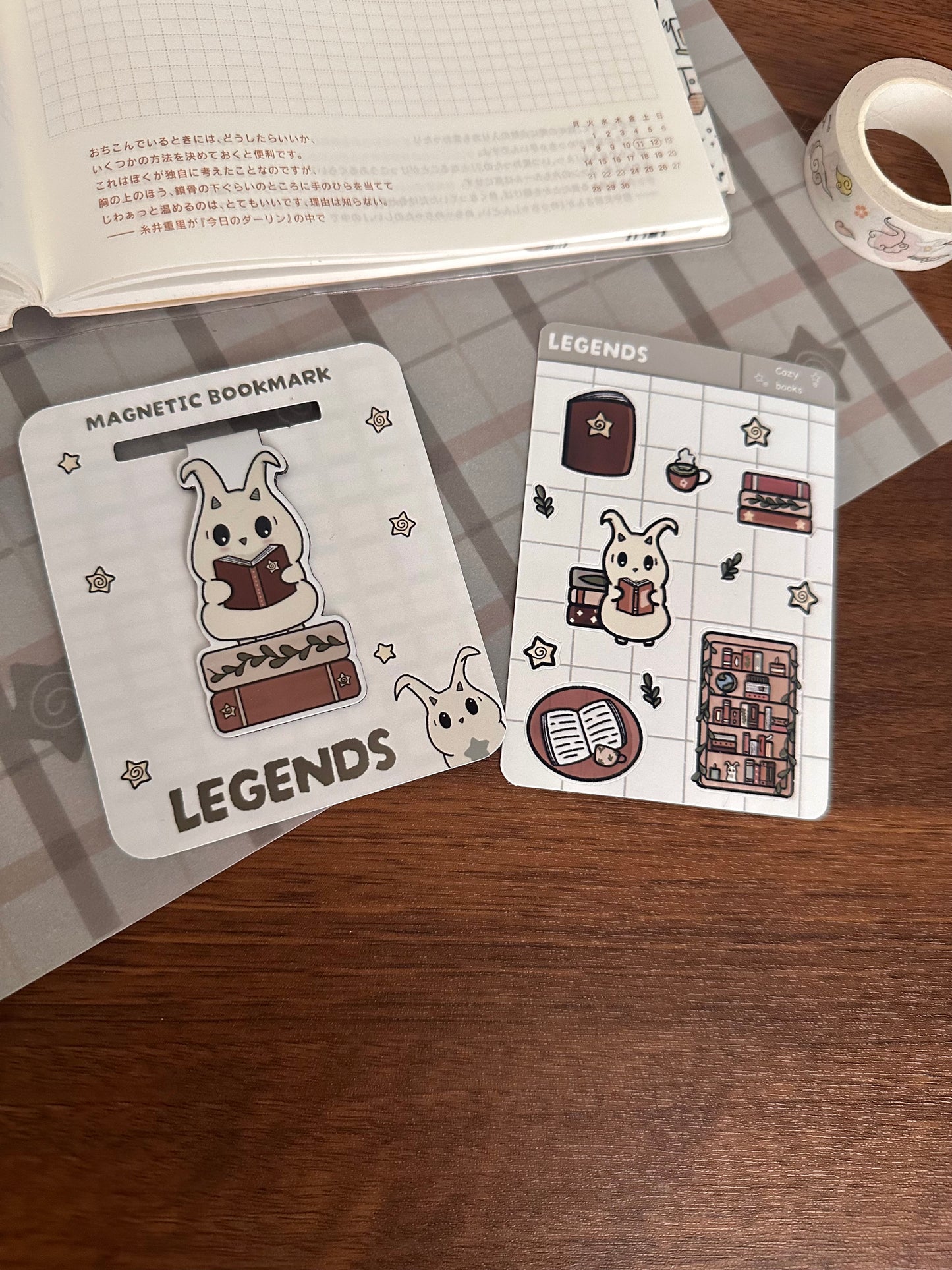 Lün magnetic bookmark, has him reading a book standing on books and a freebie sticker sheet with books