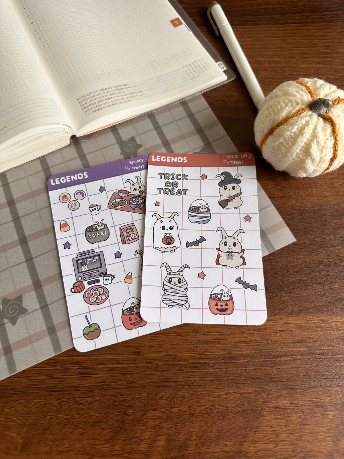 Two cute Halloween stickers sheets on a wooden desk 