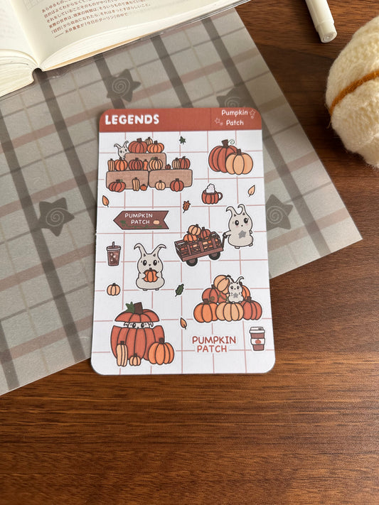 Pumpkins sticker sheet on top of a wooden desk and journal 
